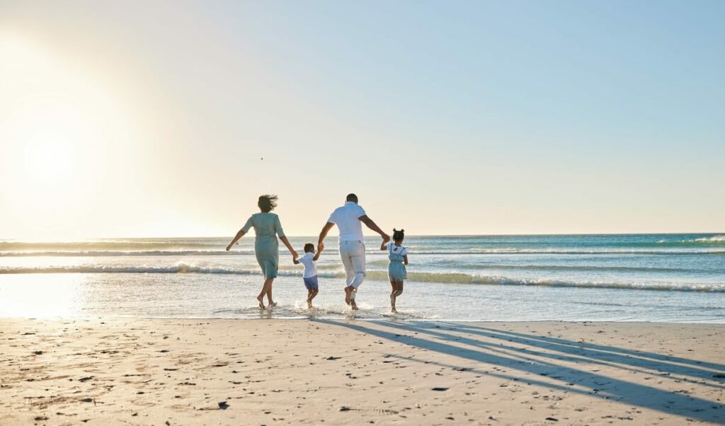 Family enjoying their time under the sun by the ocean