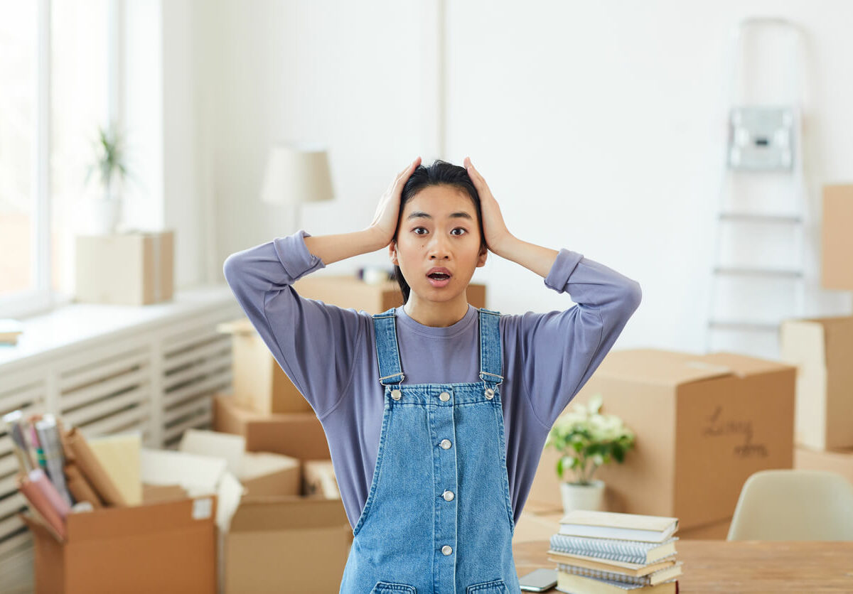 Woman concerned with boxes taking up space behind her.