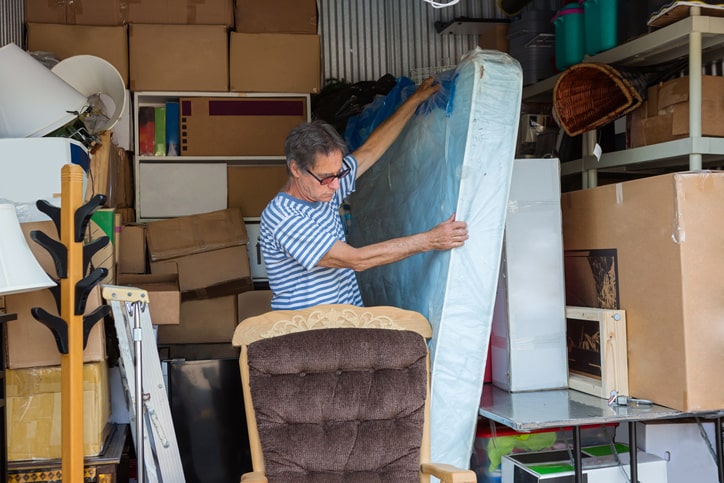 A person moves the largest items out of their unit first to clear up space