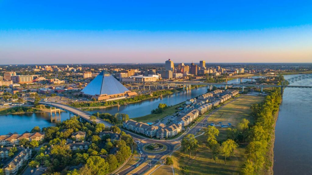 A sunset aerial view of Downtown Memphis, TN, and Bass Pro Shops at the Pyramid. 