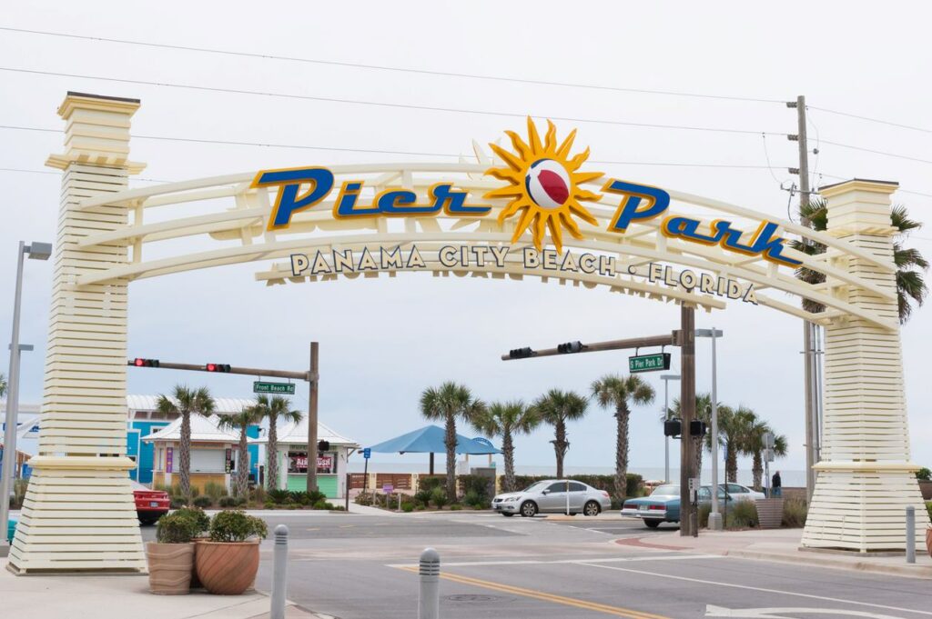 View of the sign at the entrance to Panama City Beach, reading “Pier Park”.